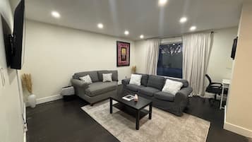Relax in this stylish living room with two sofas, a coffee table, and a beautiful view through the large window.