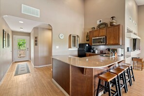 Prepare meals and socialize in this kitchen with a spacious island and sleek cabinetry.