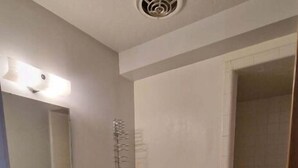 A bathroom with a toilet, sink, and shower. - Family Suite - Economy (Garden City)