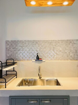 Fridge, microwave, coffee/tea maker, cookware/dishes/utensils