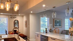 A modern kitchen with a marble countertop, stainless steel appliances, and pendant lighting. - Stately 5-bedroom estate in beautiful Prince Edward with fitness room, AC (Prince Edward)