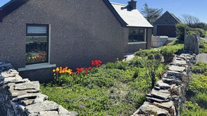 A house with a stone facade, a chimney, and a window. - Withi-Gill - Bay of Ireland Views 50m From Beach (Stromness)