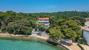 A coastal property with a large house, a small building, and a beach area. - Sunset By The Sea /w Sea View Balcony, Lopar, Croatia (Lopar)