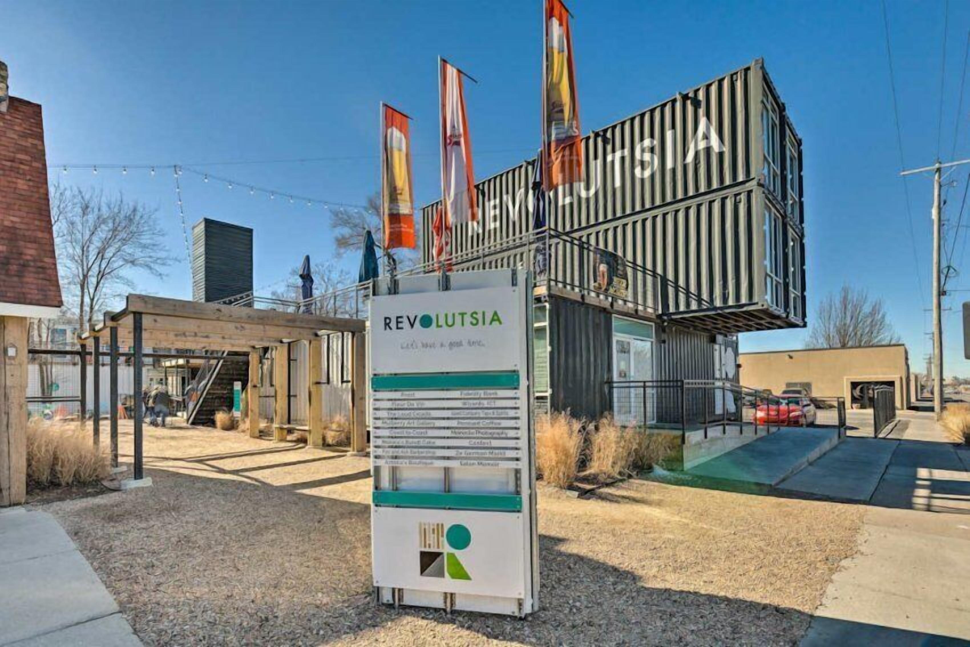 A modern building with a sign reading "REVOLTISIA" and a wooden structure nearby.