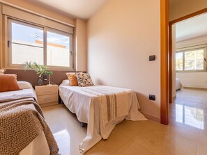 Ein Schlafzimmer mit Bett, Nachttisch und Fenster.