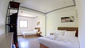 A hotel room with two beds, a wooden desk, a ladder, and a painting on the wall. - Lucky Tito Diving Inn Coron (Coron)