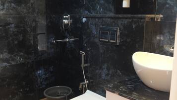 Deluxe tweepersoonskamer | Badkamer | Een douche, een haardroger, handdoeken
