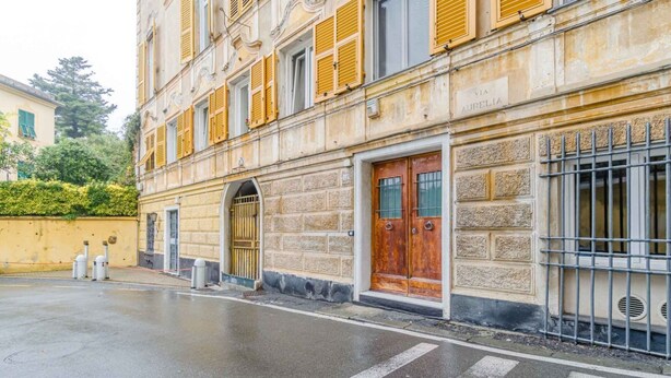 A building with a stone facade, a wooden door, and a metal gate. - GuestHost - 80 sqm apartment for 3 people, located on the ground floor (steps required for access). Just a 6-minute drive from Caprafico Beach, the accommodation is in Nervi, one of the most charming districts of Genoa, known for its parks, historic vill (Genova)