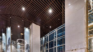 A modern lobby with a high ceiling, large windows, and contemporary furniture. - Hangzhou Binjiang Qianchao New Century Hotel (Hangzhou)