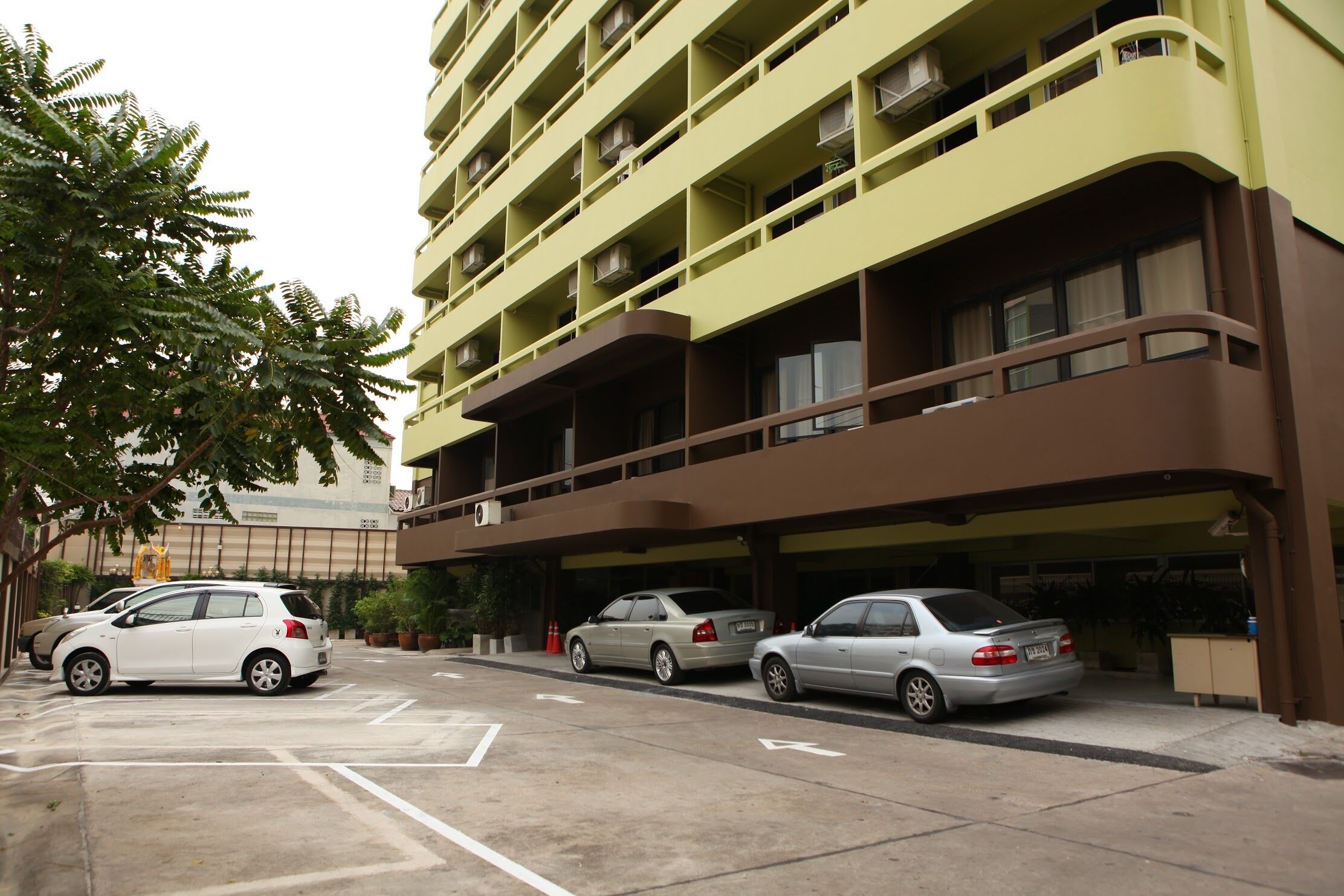 A multi-story parking garage with several cars parked.