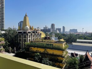 A multi-story building with a yellow facade and a large dome structure. - Petch Tower Ekkamai (Bangkok)