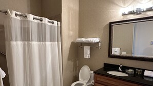 A bathroom with a shower, toilet, sink, and a large mirror. - Sun-Soaked Condo near Old Town (La Quinta)