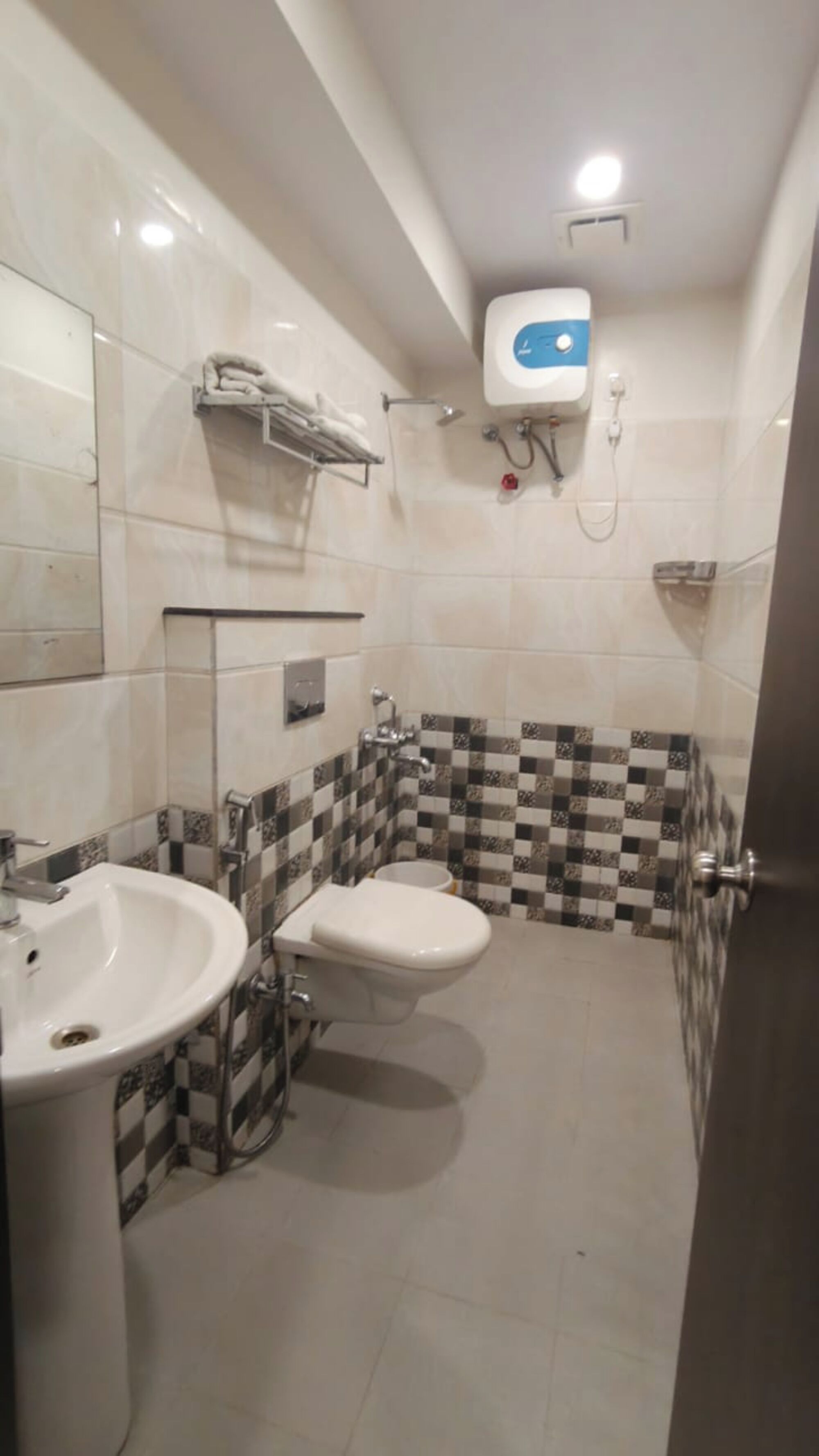 A bathroom with a sink, toilet, and shower.