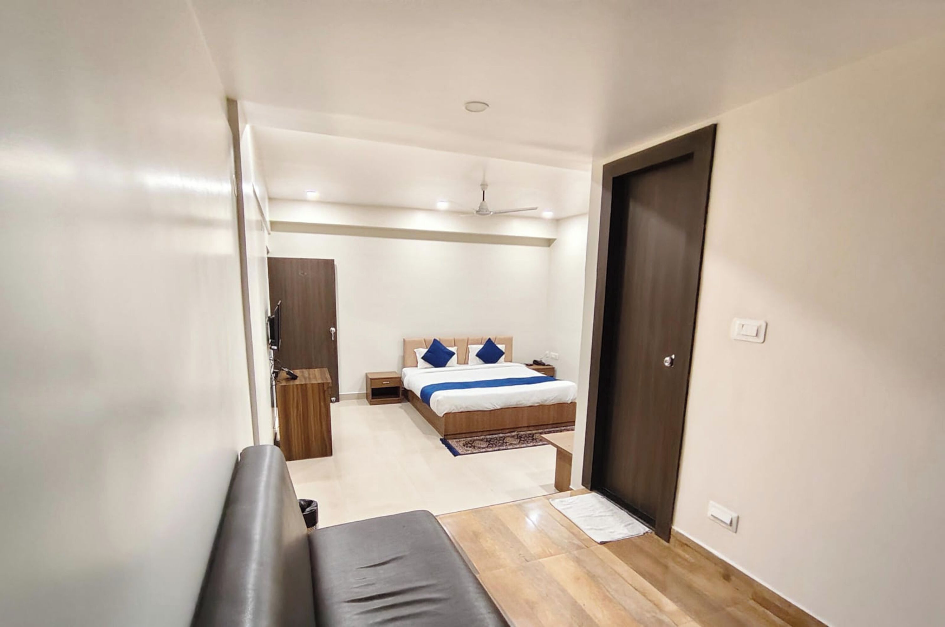 A bedroom with a bed, bedside table, and a wardrobe.