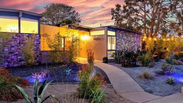 A modern house with a stone facade, a well-maintained garden, and a clear sky. - La Jolla Oasis | 4BR Luxury | Hot Tub | Close to Beach | Sleeps 12 (San Diego)