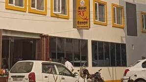 A multi-story hotel with a yellow and white facade, large windows, and balconies. - RUDRA GANGA HOTEL (Varanasi)