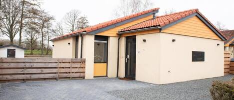 A small, single-story building with a tiled roof and a beige facade.