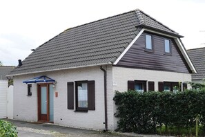 Cozy single-story home with a pitched roof and a welcoming porch.