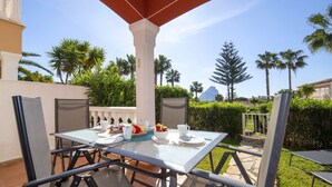 An outdoor patio with a table set for dining, surrounded by chairs and a pergola structure. - Bel-Air by Interhome (Calpe/Calp)