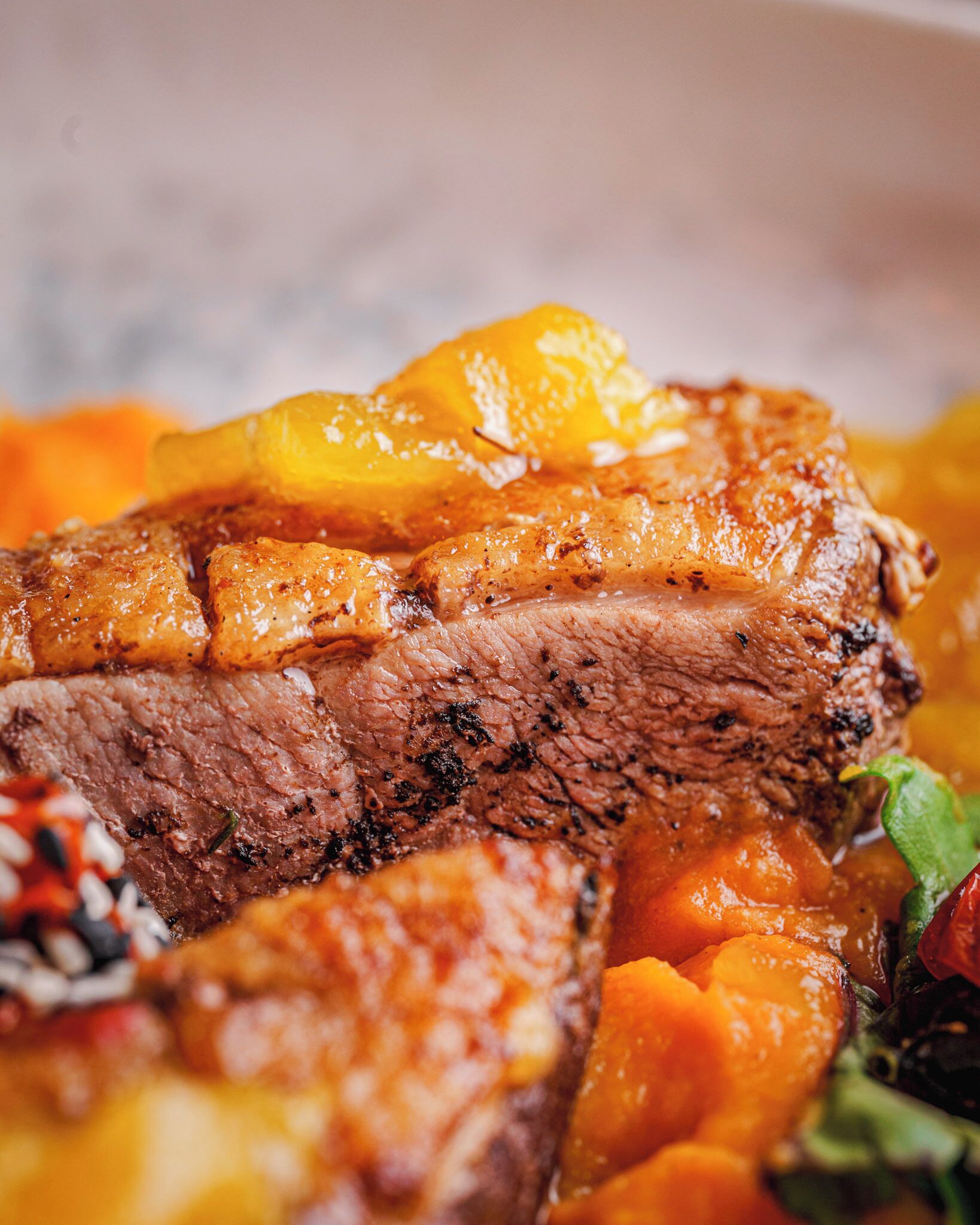 A close-up of a cooked dish with meat and vegetables.