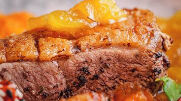 A close-up of a cooked dish with meat and vegetables.