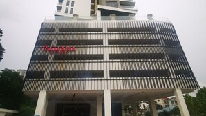 A tall building with a modern design, featuring a prominent "RAMADA" sign on the facade. - Sam's Vacation @ The Straits Suite Residence formerly Ramada Suite by Wyndham (Johor Bahru)