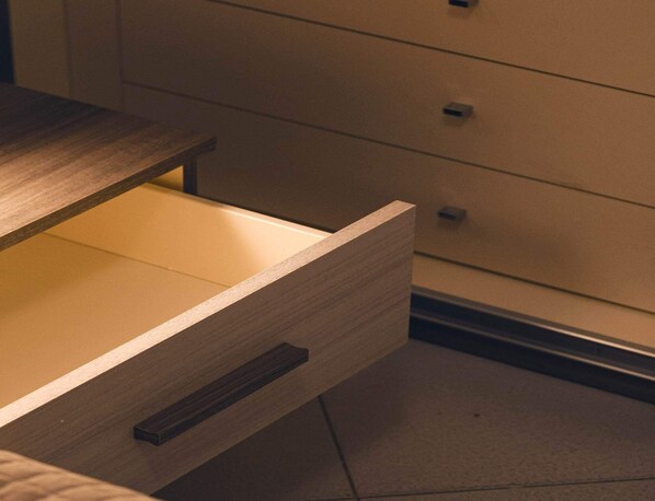 A wooden drawer with a handle, part of a piece of furniture with a light brown finish. - CASA BEDA in the Borgo (Chiavari)