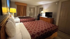 A hotel room with two beds, a television, a dresser, and a door. - Garden inn and suites san antonio l 35 (San Antonio)
