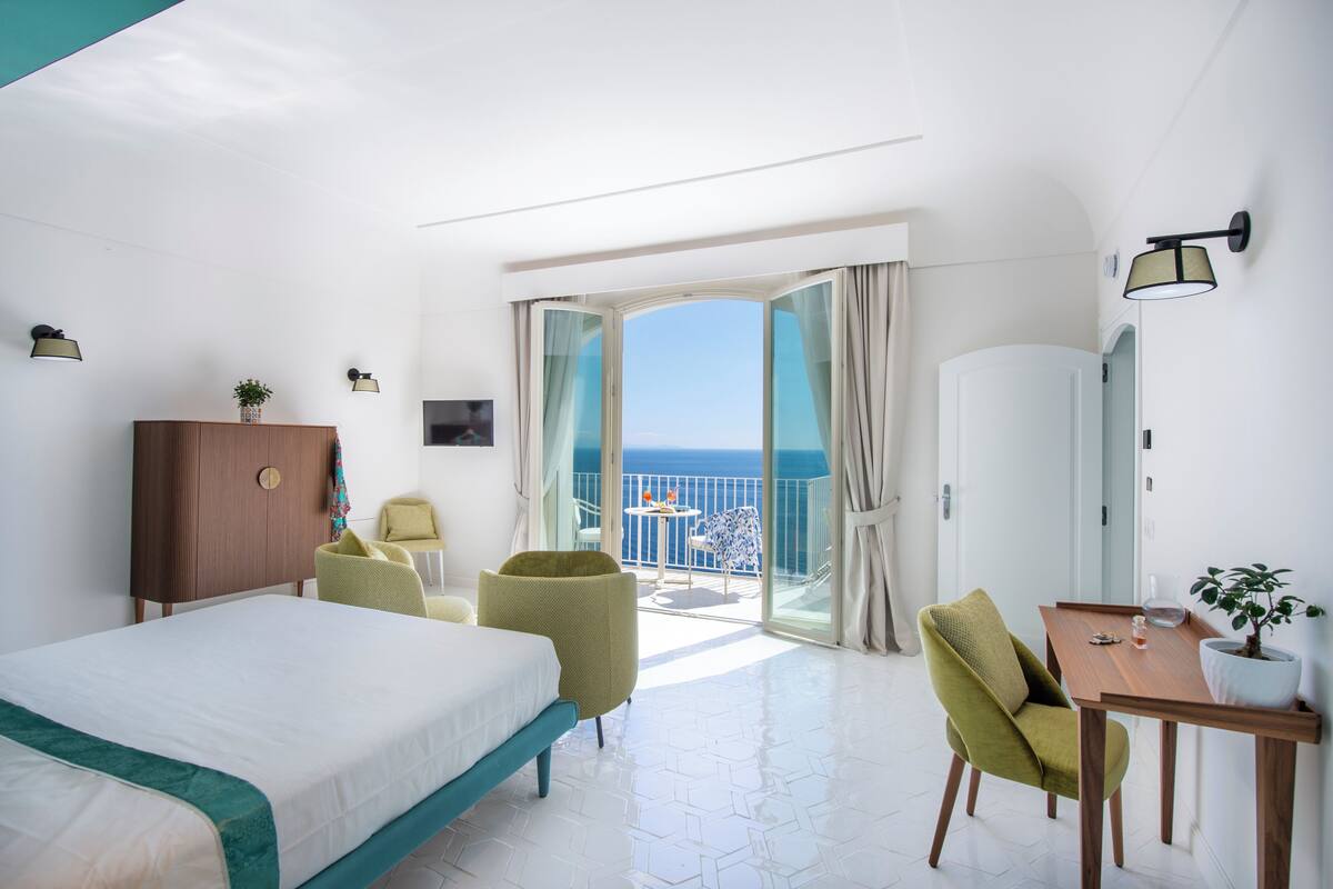 Deluxe Triple Room, Sea View | In-room safe, desk, laptop workspace, blackout drapes
