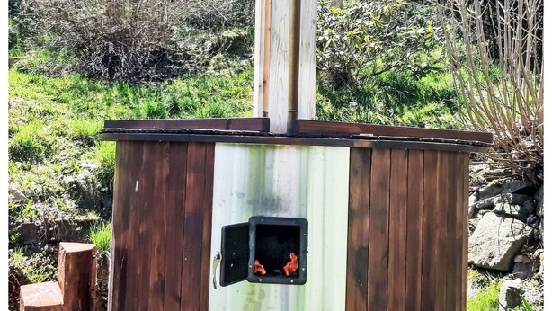 A wooden structure with a chimney, a small window with a handle, and a metal box on the side. - Wonderful private villa for 11 people with WIFI, terrace and pets allowed (Ceský Krumlov)