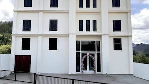 A white multi-story building with a sign reading "HOTEL" and "BELLA COSTA" above the entrance. - Hotel Bella Costa (Ludhiana)