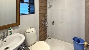 A modern bathroom with a toilet, sink, and shower. - Amore Villa (Mahabaleshwar)