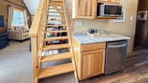 A modern kitchen with wooden cabinets, a stainless steel refrigerator, and a built-in microwave. - Alpine Horn # 1 ~ Sauna & Close to Powderhorn! (Bessemer)