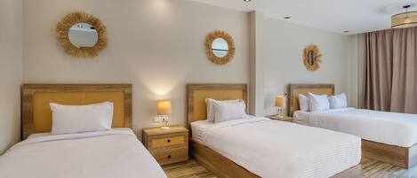 A hotel room with two beds, wooden headboards, and a large mirror on the wall.