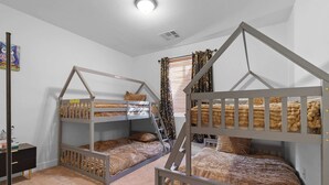A child’s bedroom with bunk beds, a desk, and a window with curtains. - Family Friendly  w/ Badminton | Goodyear Park (Goodyear)
