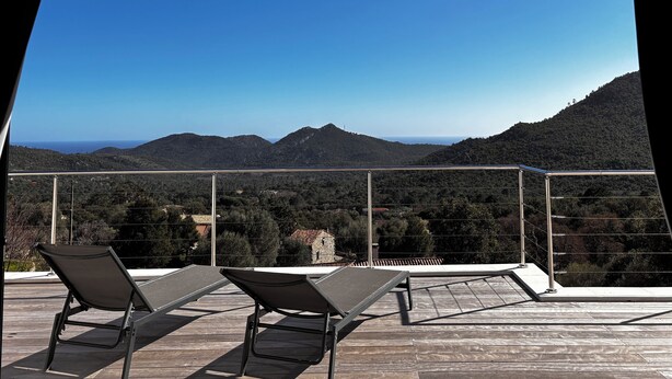 A balcony with two lounge chairs overlooking a mountainous landscape. - Villa located between sea and mountains (Conca)