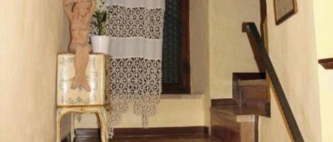 A staircase with wooden steps and a white curtain.