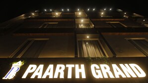 A building with illuminated signage reading "PAARTH GRAND". - Treebo Paarth Grand (Haridwar)