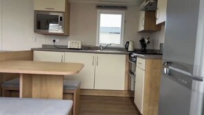Cabin | Private kitchen | Fridge, microwave, oven, stovetop