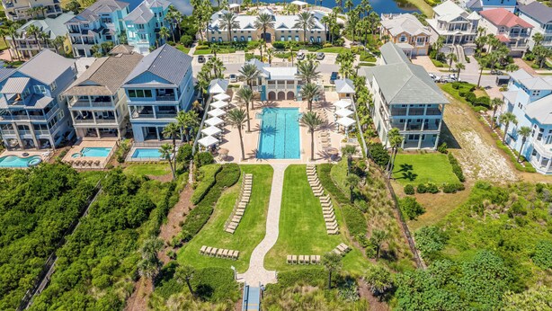 An aerial view of a resort with multiple buildings, a central pool, and well-maintained lawns. - Gorgeous Sunsets, 2 minutes to the beach - Cinnamon Beach 1032! (Palm Coast)