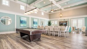 A spacious room with a pool table, dining area, and ceiling fans. - Gorgeous Sunsets, 2 minutes to the beach - Cinnamon Beach 1032! (Palm Coast)