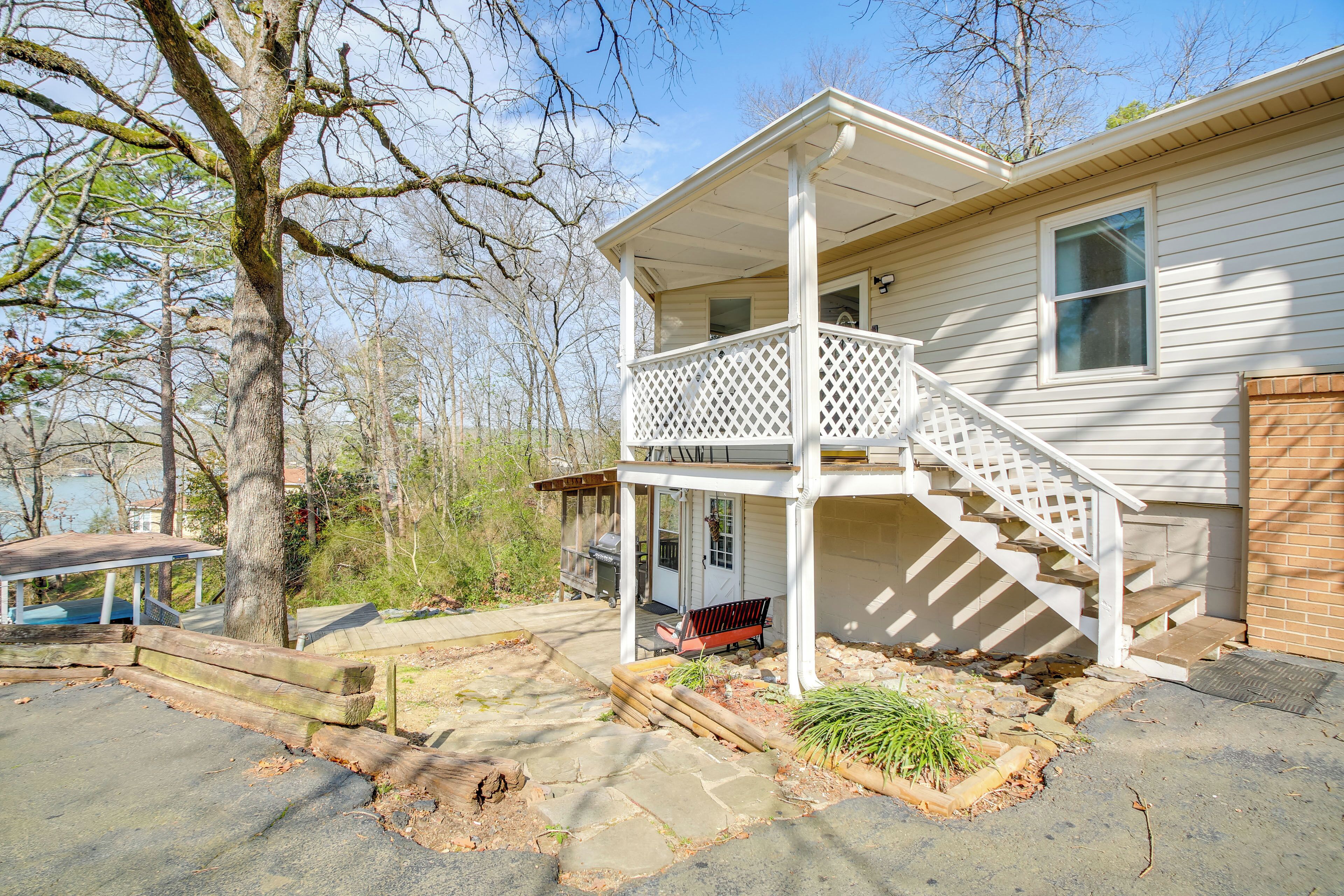 A two-story house with a covered porch and a front porch with a bench.