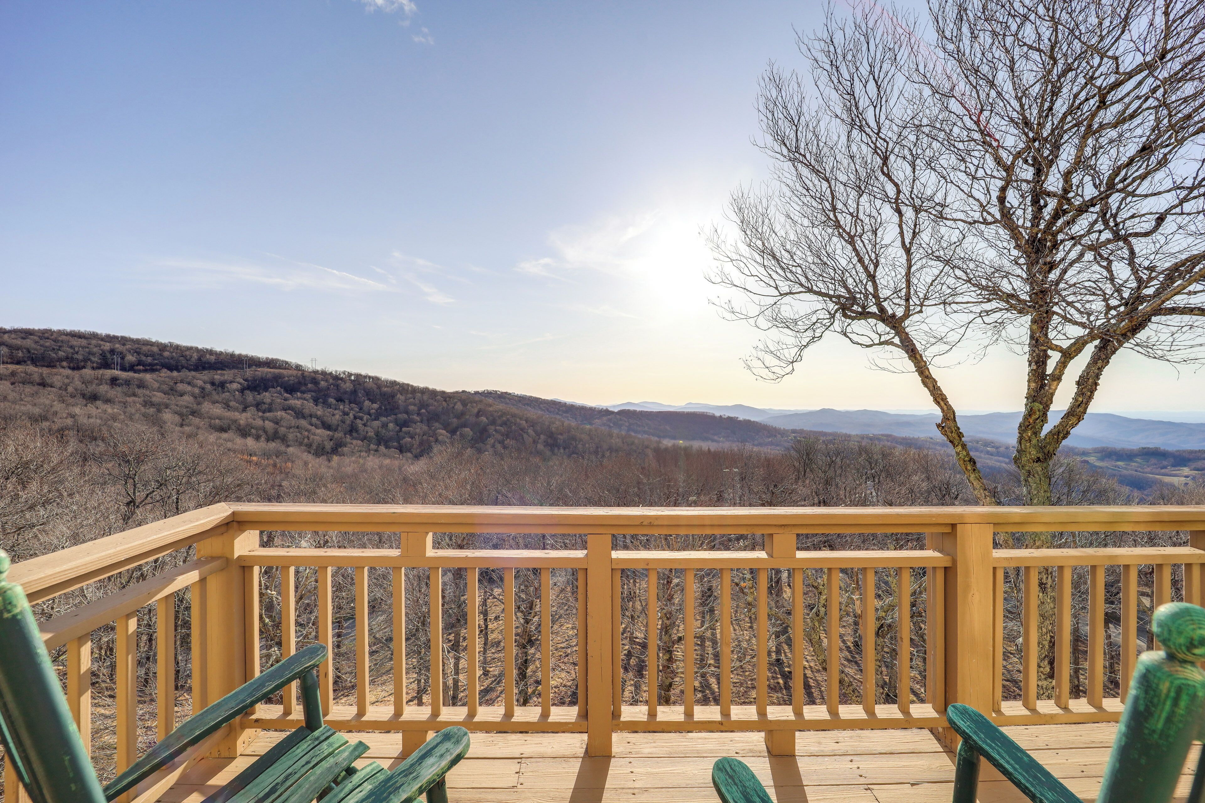 A wooden deck with a view of a mountainous landscape.