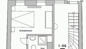 Un plan d’étage comprenant une chambre, une salle de bain, un salon et une cuisine.