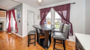 A dining area with a round table, two chairs, and a chandelier. - Big Sky Retreat - Home for 10 (Fairfield)