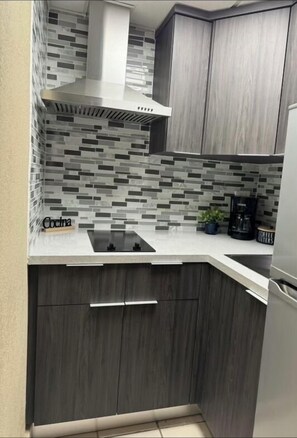 Fridge, microwave, stovetop, coffee/tea maker