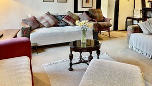 A living room with a sofa, armchairs, a coffee table, and a fireplace. - Toad Hall Swilland, a beautiful, 5 bedroom country residence surrounded by Suffolk countryside (Swilland,)