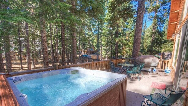 A hot tub surrounded by wooden deck, outdoor furniture, and a barbecue grill. - Coh1669 - Hawk's View Hideaway 6 Bedroom Home (South Lake Tahoe)