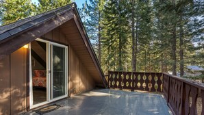 A wooden deck with a glass door leading to a bedroom. - Coh0885 - Skyline Divine 4 Bedroom Home (South Lake Tahoe)