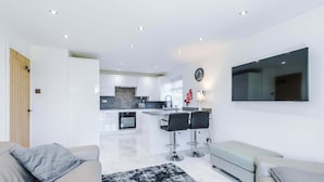 A modern living room with a sofa, a coffee table, and a rug. - Cosy 1BR Apt in Manchester with Free Parking (Manchester)
